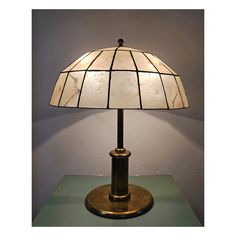 In this listing you will find a Mid Century Modern Brass Table Lamp with handmade Dome-Shaped Shade made of Capiz Shell and Brass. The lamp features two bulb sockets. ORIGIN: Italy PERIOD: 1960s CONDITION: Very good vintage condition with some signs of time and use such as patina. The shade has no damage When purchased the lamp will be carefully wrapped up and packed in a way to avoid any damages in transport.  As soon as shipped you will receive the tracking number for your package.  If you hav Shell Table Lamp, Shell Table, Table Lamp Vintage, Capiz Shell, Lamp Vintage, Vintage Lamp, Brass Table, Brass Table Lamps, Vintage Table Lamp