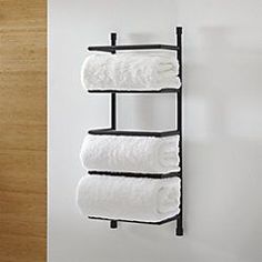 three white towels are hanging on a towel rack