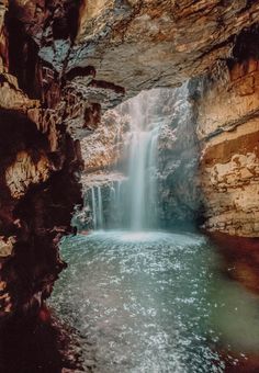 a small waterfall in the middle of a cave