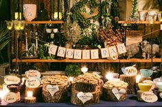 a table topped with lots of desserts and candles