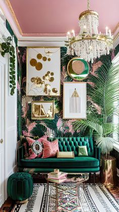 a living room with green velvet couches, pink walls and gold chandelier