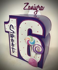 the number six is decorated with candy and lollipops