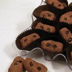 chocolate chip cookies are arranged in a pyramid on a white tablecloth, with one cookie shaped like a bear