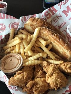 fried chicken and french fries in a basket with dipping sauce on the side at a fast food restaurant