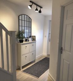 a hallway with white walls and black accents