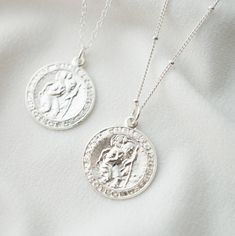 "Our Saint Christopher traveler's necklace is perfect for everyday, a statement piece that looks amazing layered, or stunning on its own. Saint Christopher is the patron saint of travelers, keeping them safe on their journey. The pendant and necklace are made of high quality sterling silver and is also available in 14K gold fill. *Free shipping for orders to USA and Canada, and no duties and customs fees.* > Charm says \"Saint Christopher Protect Us\" > Shown worn on 18\" cable chain (1st Pharmd Graduation, Pharmacist Graduation, Silver Coin Jewelry, Mouse Necklace, St Christopher Medal, Popular Necklaces, Silver Coin Necklace, White Mouse, Travel Necklace