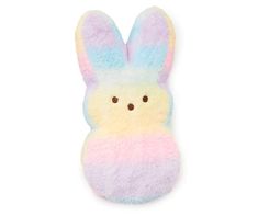 a stuffed animal with pastel colors on it's face and ears, sitting in front of a white background