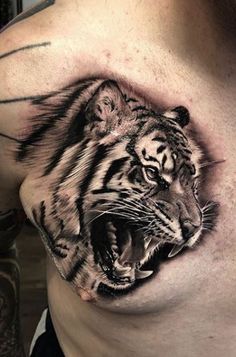 a man's chest with a tiger tattoo on his chest and an open mouth