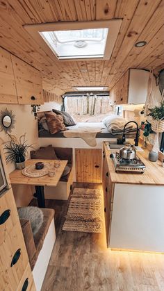 the interior of a tiny home with wood paneling and white walls, including a bed