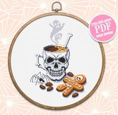 a cross stitch pattern with a skull and some cookies