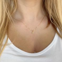 Elevate your style and showcase your astrological sign with our Gemini Zodiac Symbol 14K Gold Necklace. Handcrafted with a 14K gold filled chain and a 18k vermeil gold charm, this minimalist yet meaningful necklace is the perfect addition to your jewelry collection. Available in 16 or 18 inch necklace sizes. Celebrate yourself or a loved one with fine jewelry that shines as bright as your special day! 14k gold chain 14k lobster clasp 18k vermeil gold charm 16 & 18 necklace sizes makes a great gi Dainty Zodiac Sign Necklace For Gift, Minimalist Gold Zodiac Sign Necklace, Gold Dainty Zodiac Sign Charm Necklace, Gold Minimalist Zodiac Charm Necklace, Gemini Zodiac Symbol, Gemini Necklace, Gemini Pendant, Meaningful Necklace, Pretty Pendant