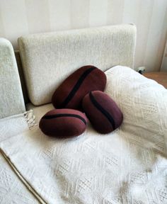 three pillows sitting on top of a bed next to a white pillow cover with black stripes