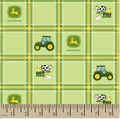 a green plaid with farm animals and tractors on it, as well as a ruler