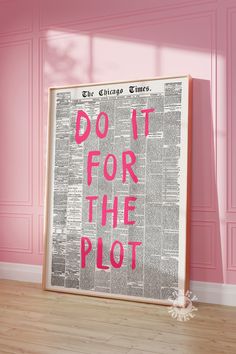 a poster with the words do it for the plot in pink on a wooden floor