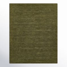 a green area rug with an uneven pattern on the top and bottom, in front of a white background