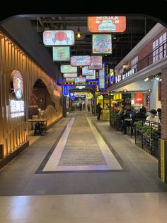 an empty shopping mall with people sitting at tables