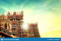 an artistic view of the top of a hindu temple in india, with bright blue sky and