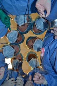 several doctors in scrubs are performing surgery