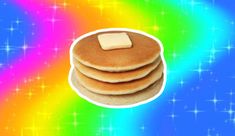 three pancakes with butter on top are in front of a rainbow background