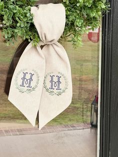 two monogrammed ties hang from the front door