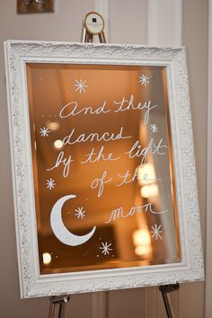 a sign that is on top of a tripod in front of a mirror with the words and they diamond if the light of the moon