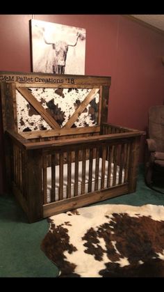 a baby crib with a cow print on the top and bottom panel, sitting in a room