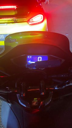 the back end of a motorcycle with its lights on