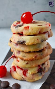 a stack of cookies with cherries on top