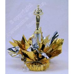 a gold and silver vase with flowers in it's center, on a white background