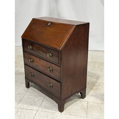 an old wooden desk with three drawers