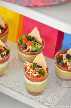 small cups filled with food on top of a table