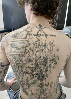 the back of a woman with tattoos on her body