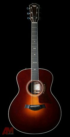 an acoustic guitar is shown against a black background with the light shining on it's neck