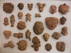 a bunch of clay heads are on display