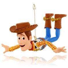 toy story woody hanging from the ceiling with his cowboy hat and boots on it's head