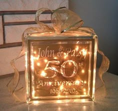 a 50th wedding anniversary light up box with lights on the front and back, sitting on top of a table