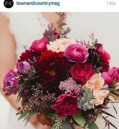 a woman holding a bouquet of flowers in her hands