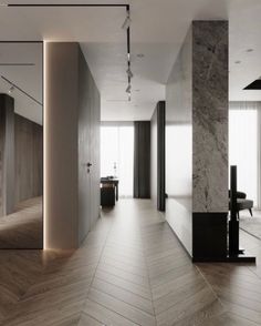 an empty room with wood flooring and white walls, leading to a dining area