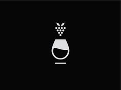 a wine glass with some grapes in it on a black background and white outlines