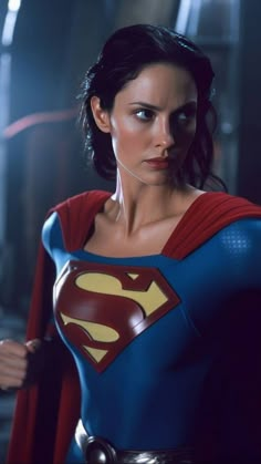 a woman in a superman costume is looking at the camera with an evil look on her face