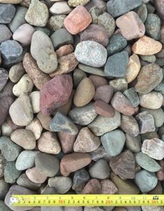 a pile of rocks sitting next to a ruler