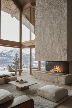 a living room filled with furniture and a fire place in front of a large window