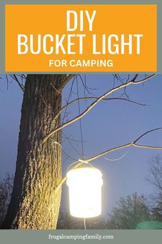 a lantern hanging from a tree with the text diy bucket light for camping