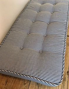 a mattress that is laying on the floor