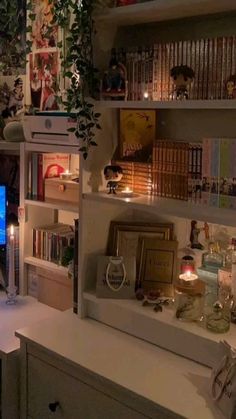 a living room filled with furniture and bookshelves next to a computer monitor on top of a desk