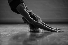 a woman is doing a handstand on the floor