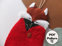 an ornament made to look like a red jacket with a fox on it