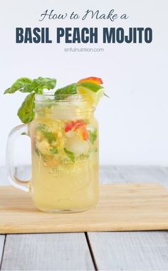 a mason jar filled with basil peach mojito