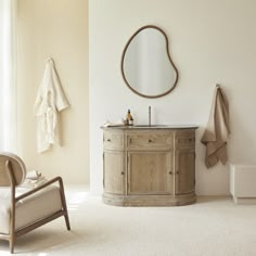 a bathroom with a sink, mirror and chair