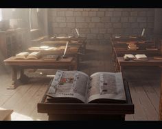 an open book sitting on top of a wooden table in a room filled with desks